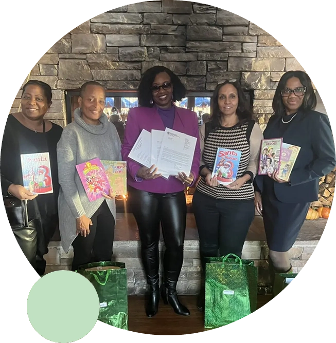 A group of women holding books and bags.