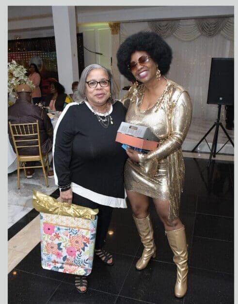 Two women in costumes posing for a picture.