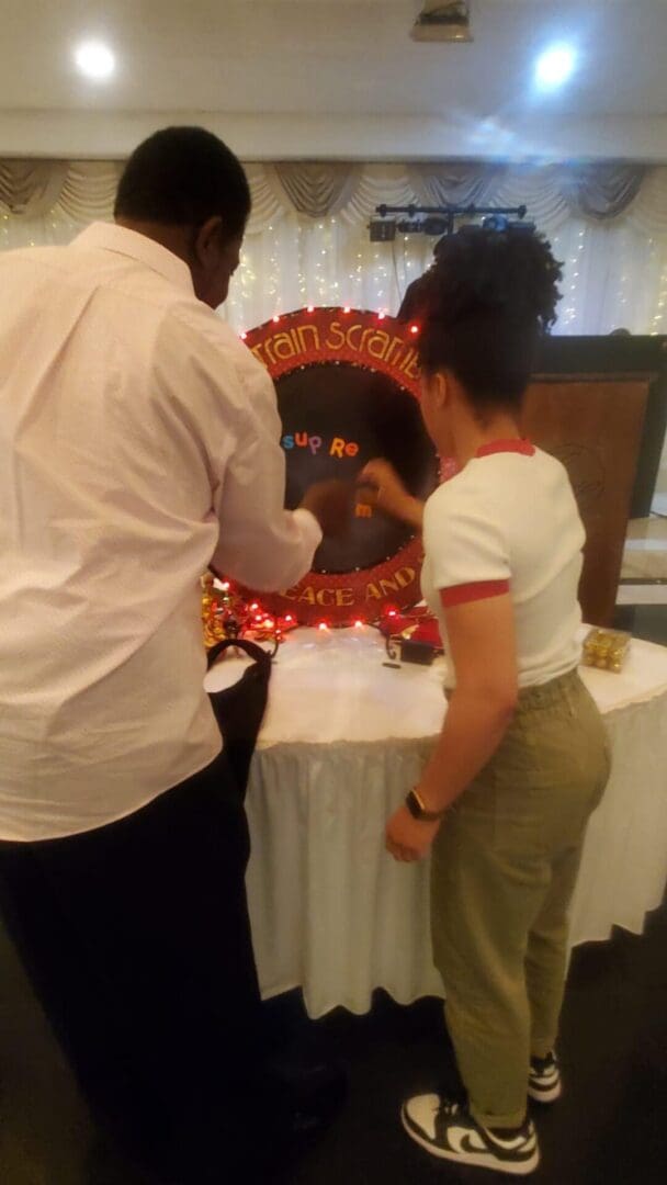 A man and woman standing at the table