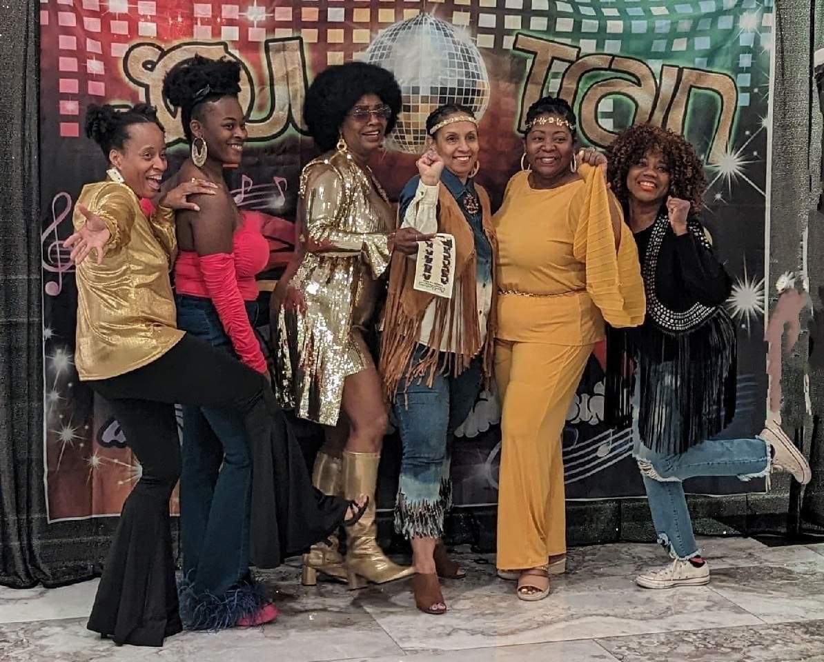 A group of women posing for the camera.