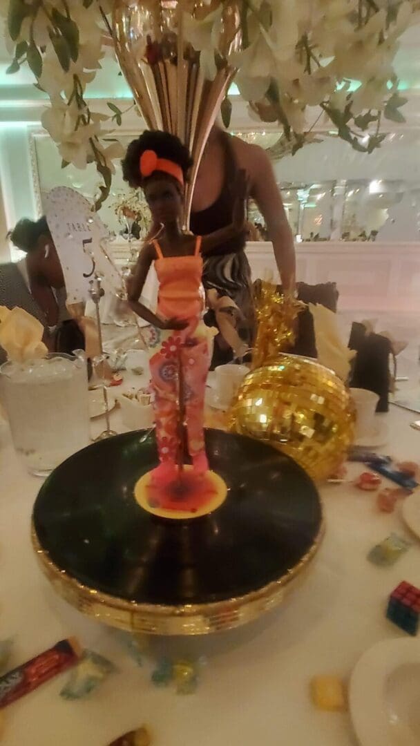 A woman standing on top of a cake.