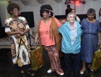 A group of older women standing next to each other.