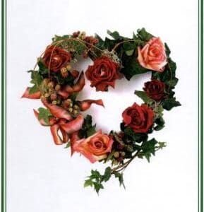 Heart-shaped floral arrangement with roses.