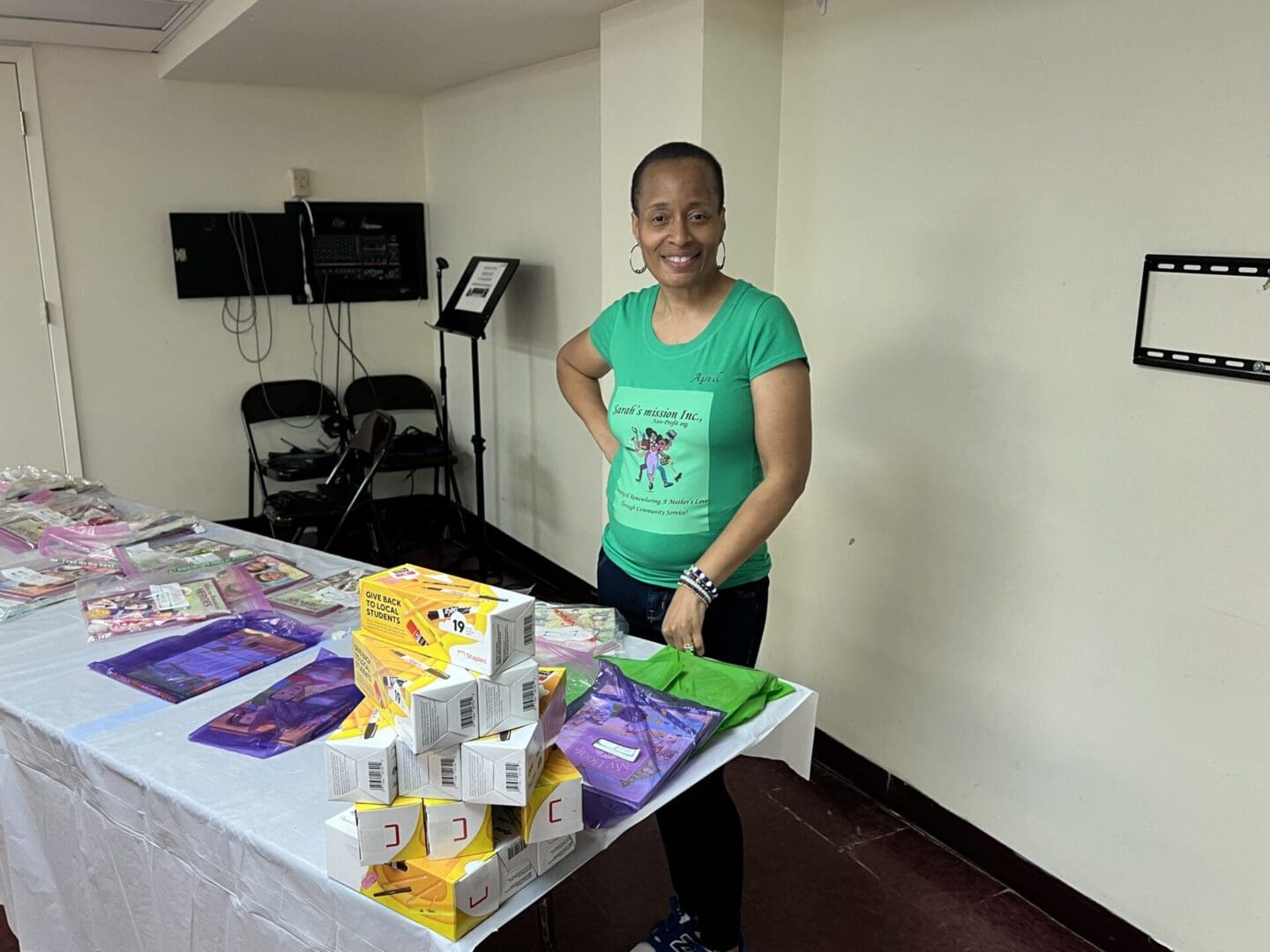 A woman standing next to a table with snacks on it.