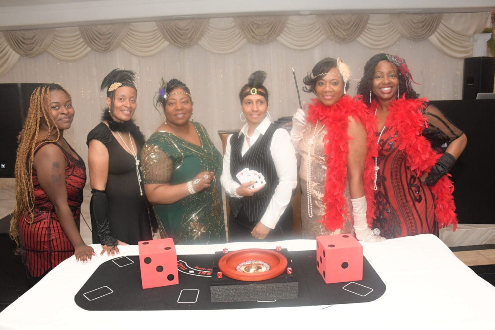 A group of women standing around a table.