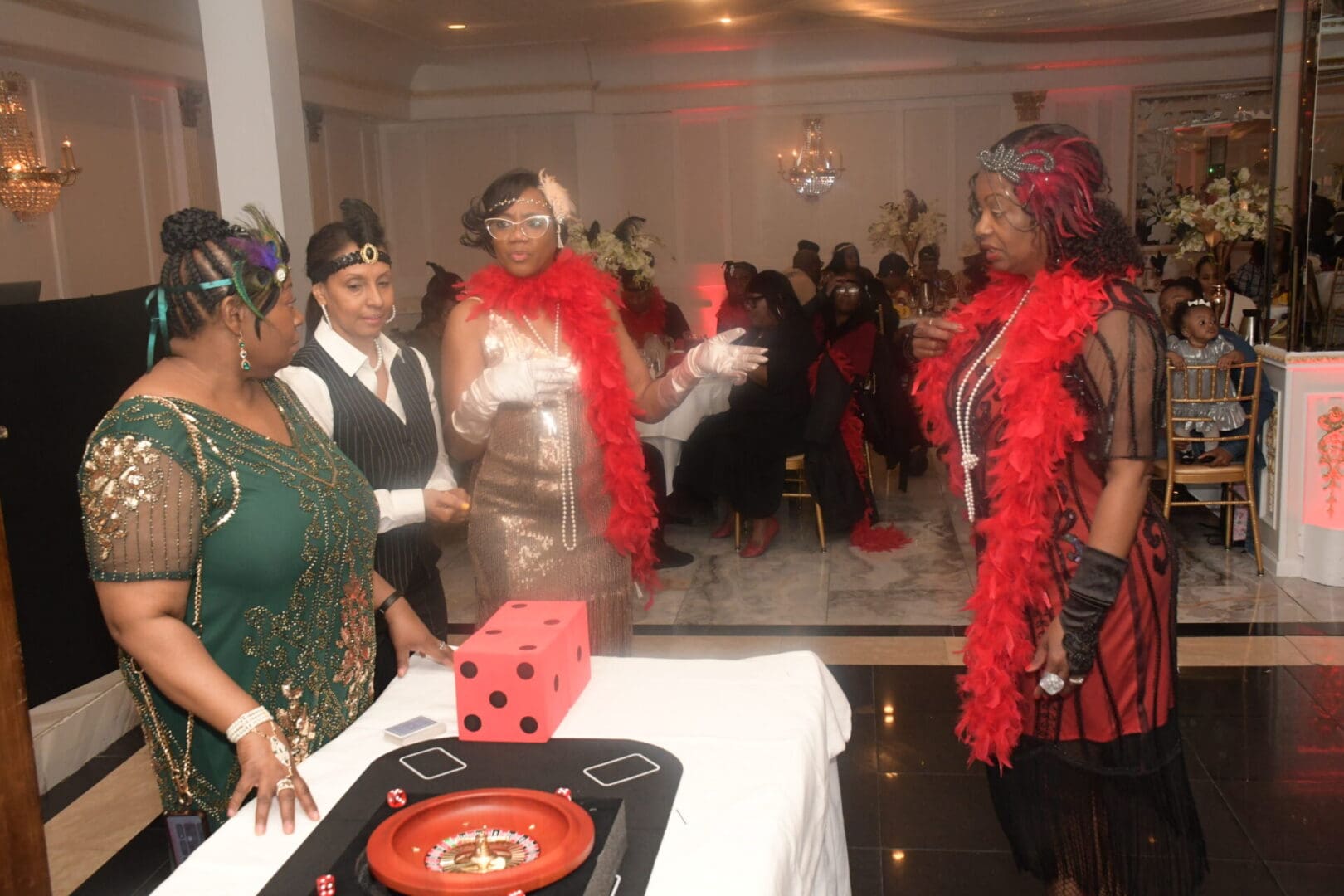 A group of women standing around a table.