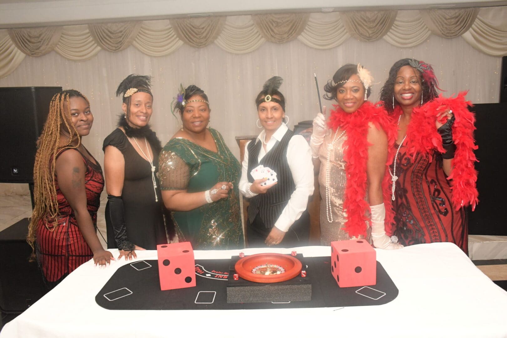 A group of women standing around a table.