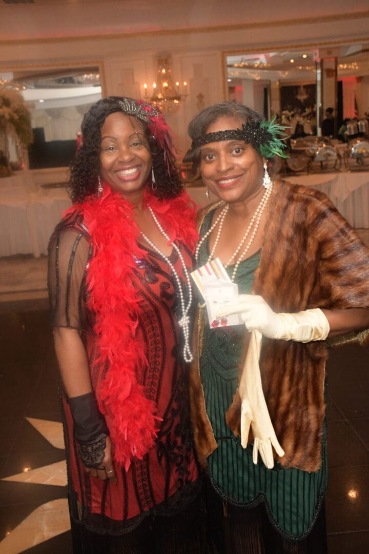 Two women dressed up in costumes for a party.