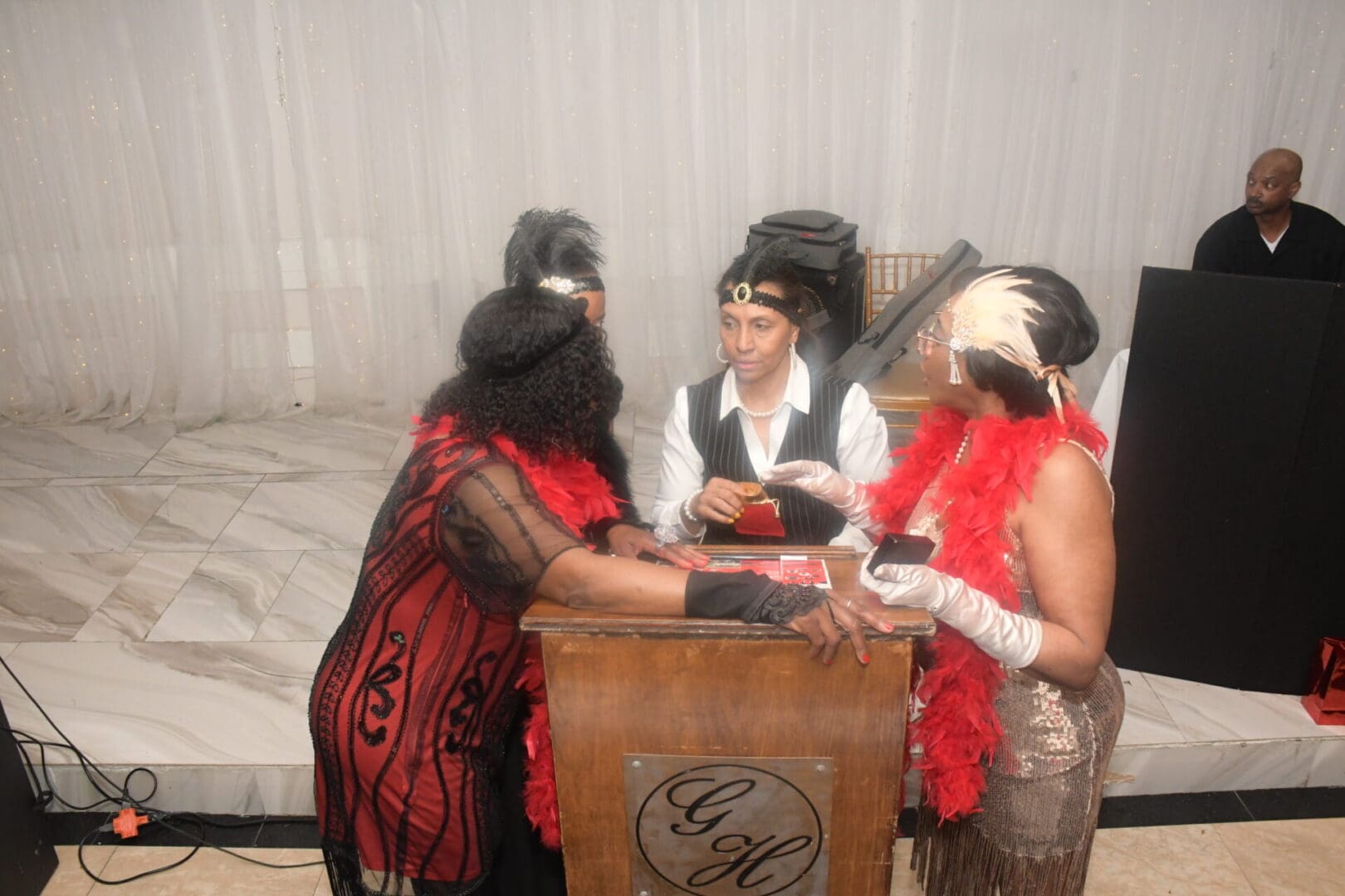 Three people in costumes playing a game of cards.