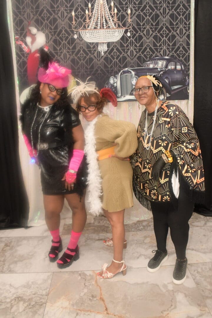 Three women dressed up in costumes posing for a picture.