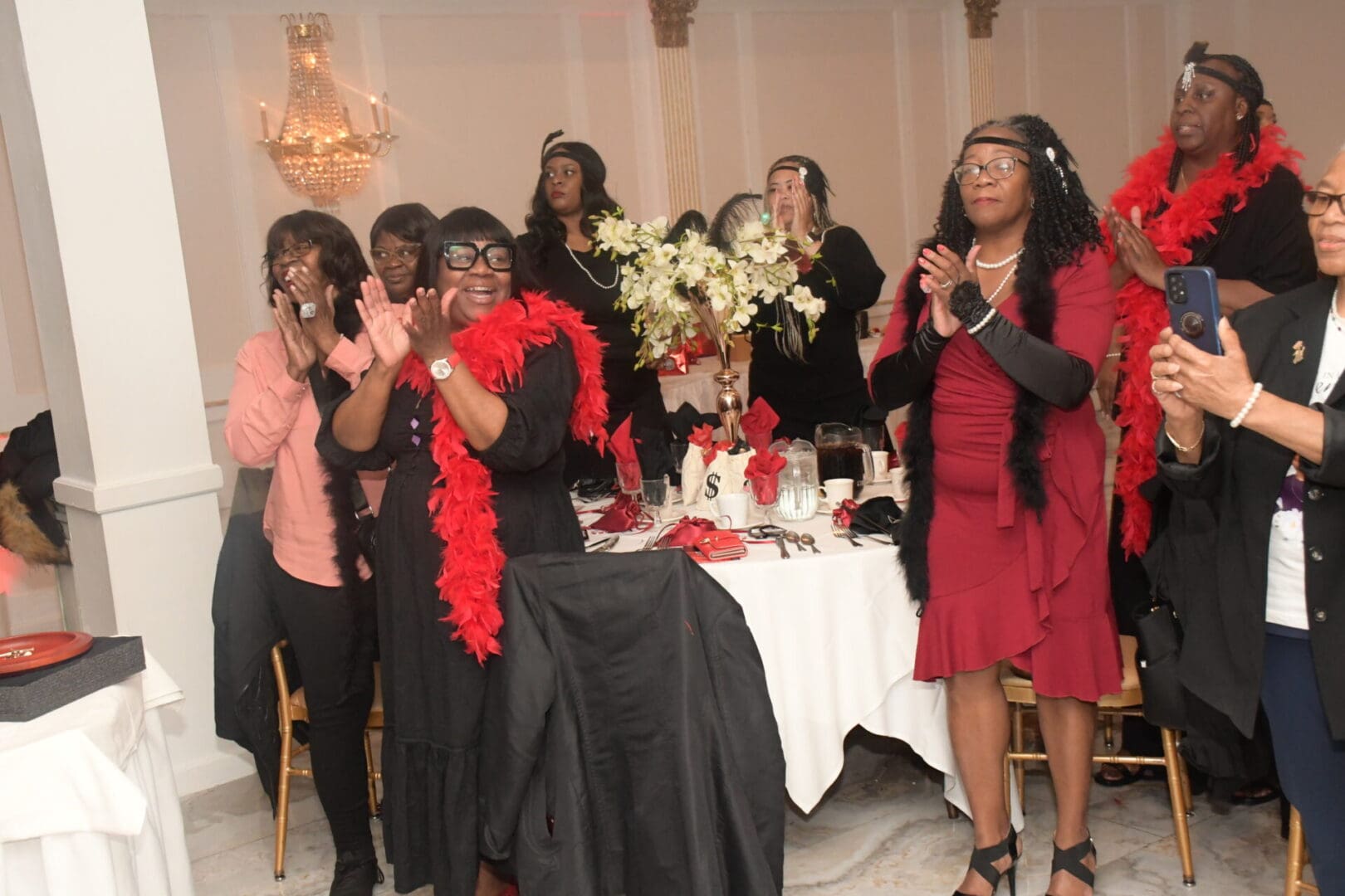 A group of women standing around a table.