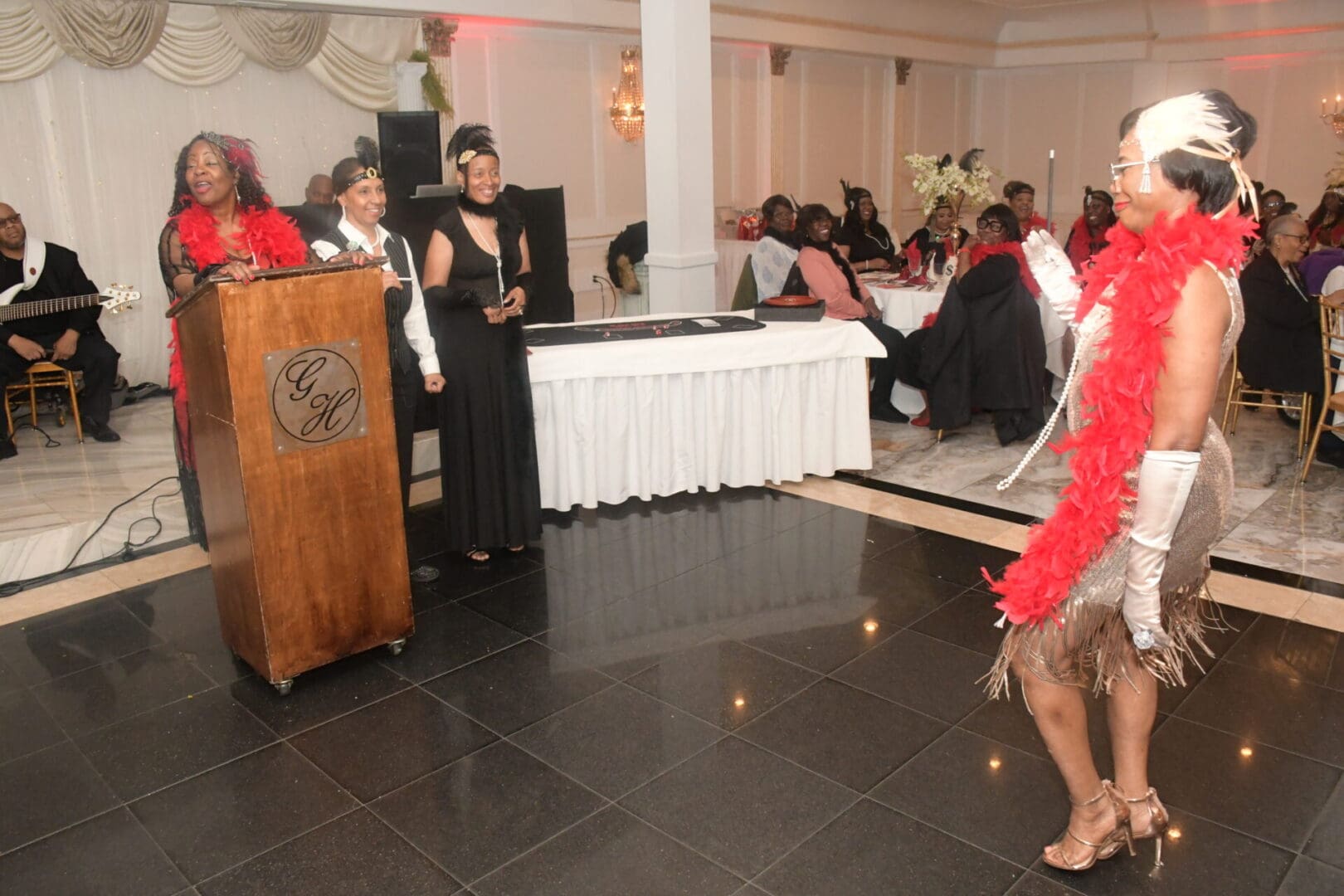 A woman in red is dancing at an event.