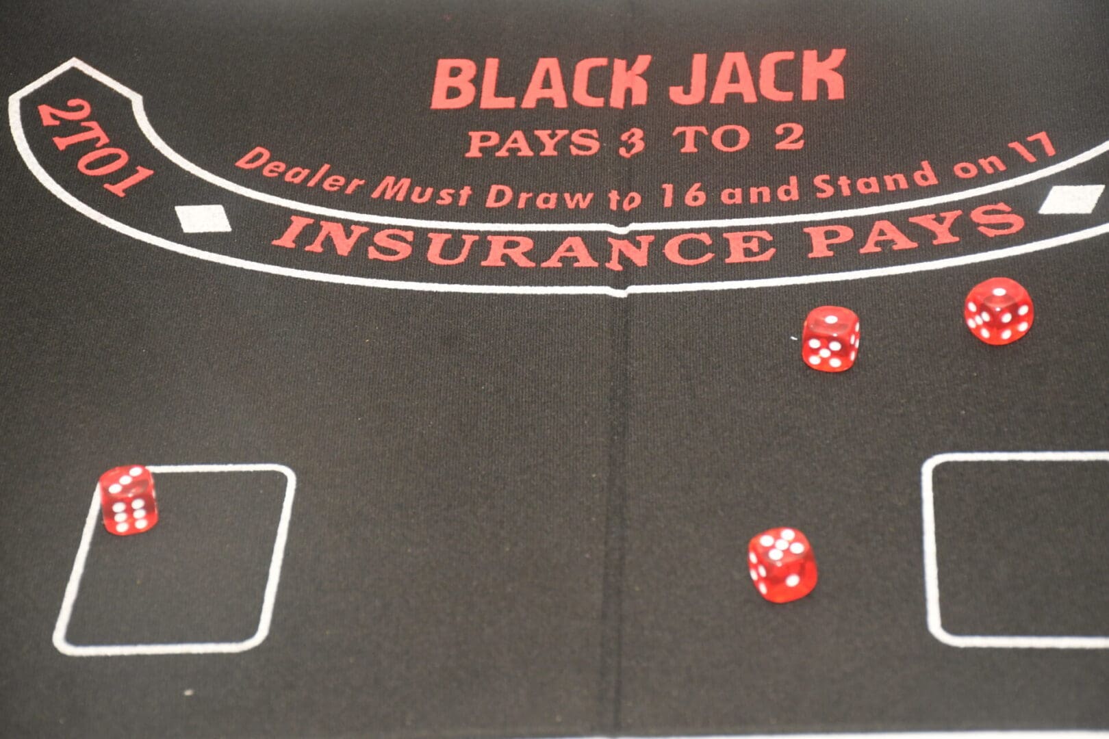 A black jack table with dice and numbers.