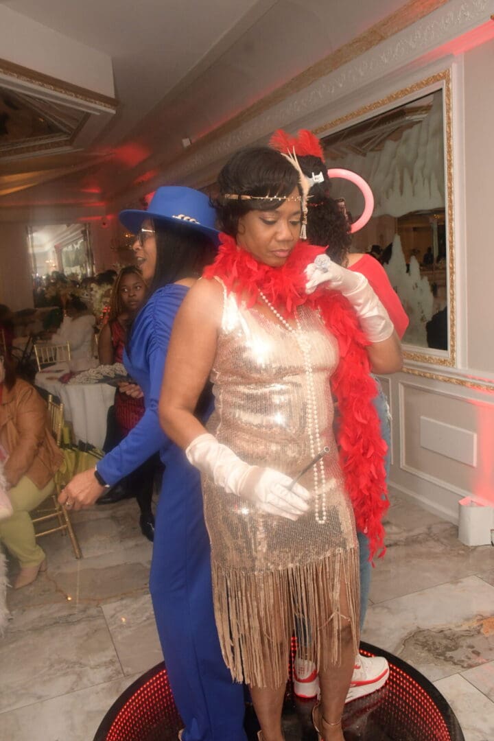 Two women in costumes are posing for a picture.