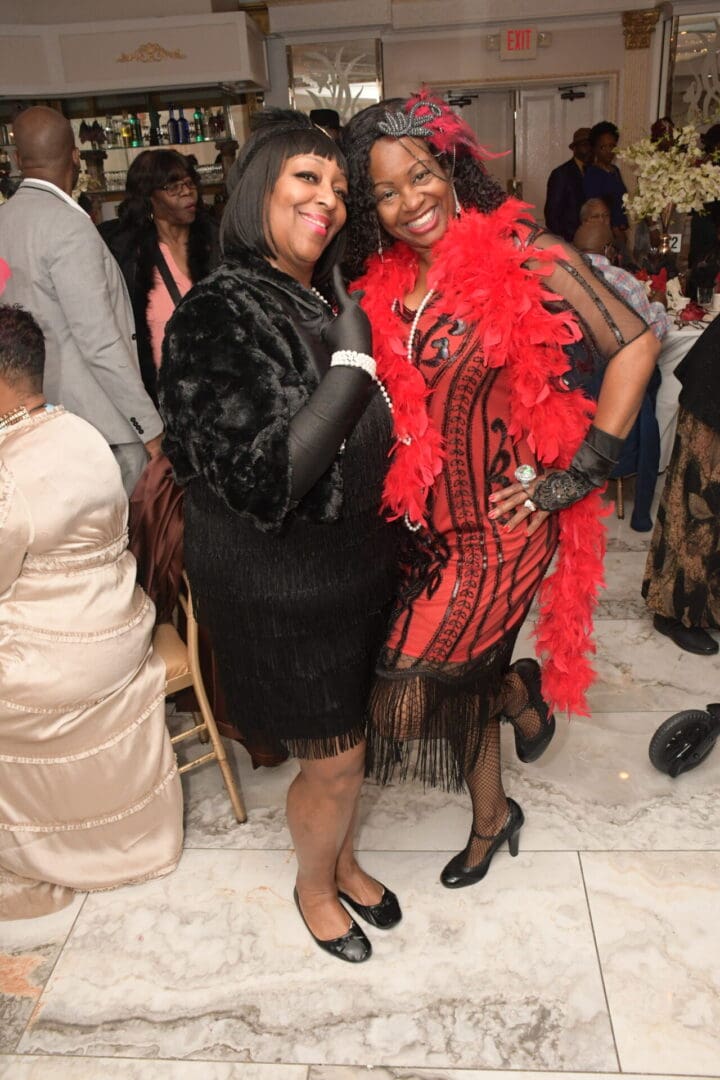 Two women posing for a picture at an event.