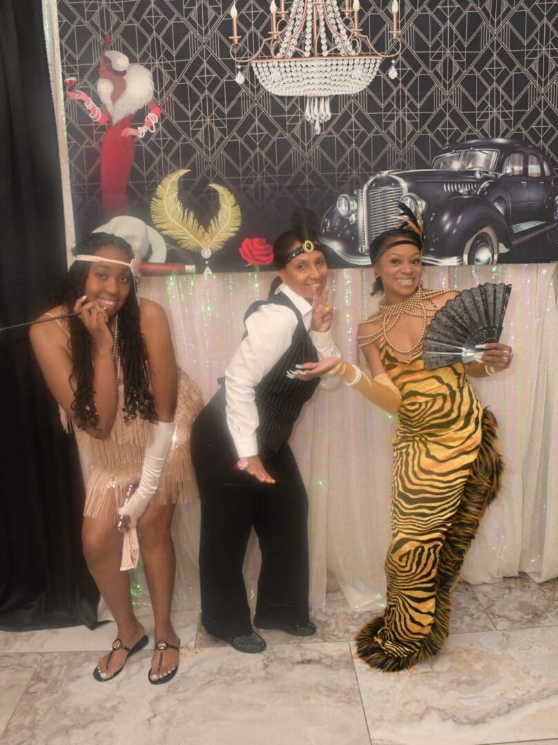 Three people posing for a picture with an animal costume.