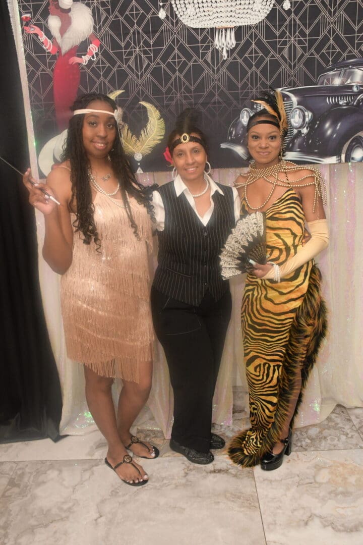 Three women dressed up in costumes for a party.