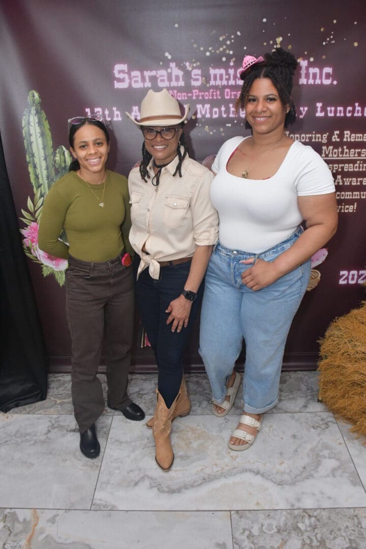 Three women smiling at a Mother's Day event.