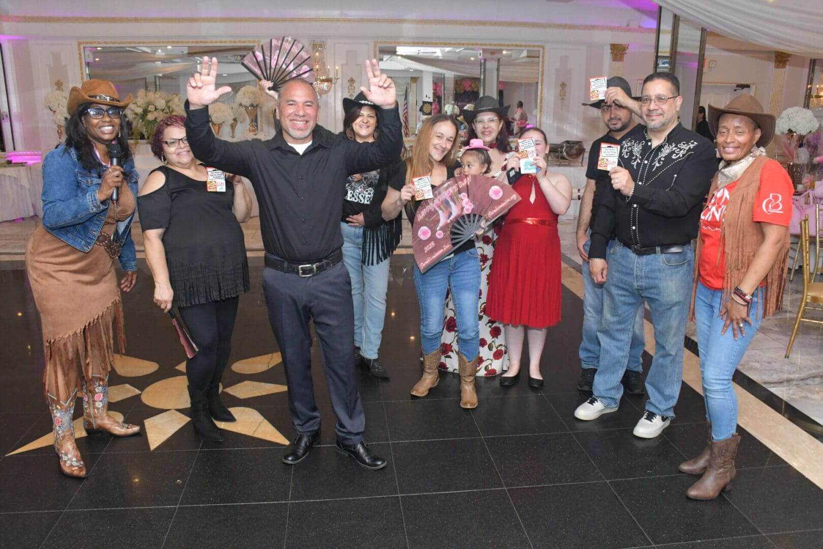 Group celebrating with cards and fans.