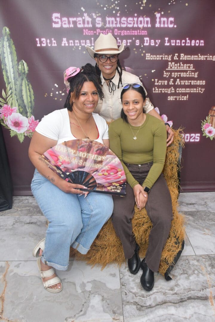 Three people posing at Mother's Day luncheon.