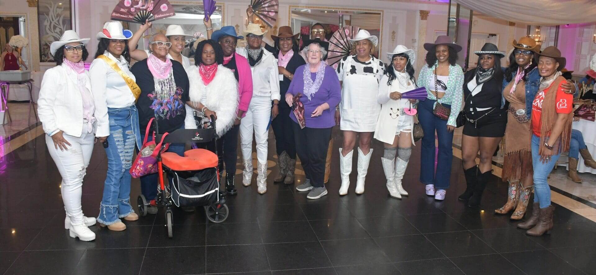 Group in western attire at indoor event.