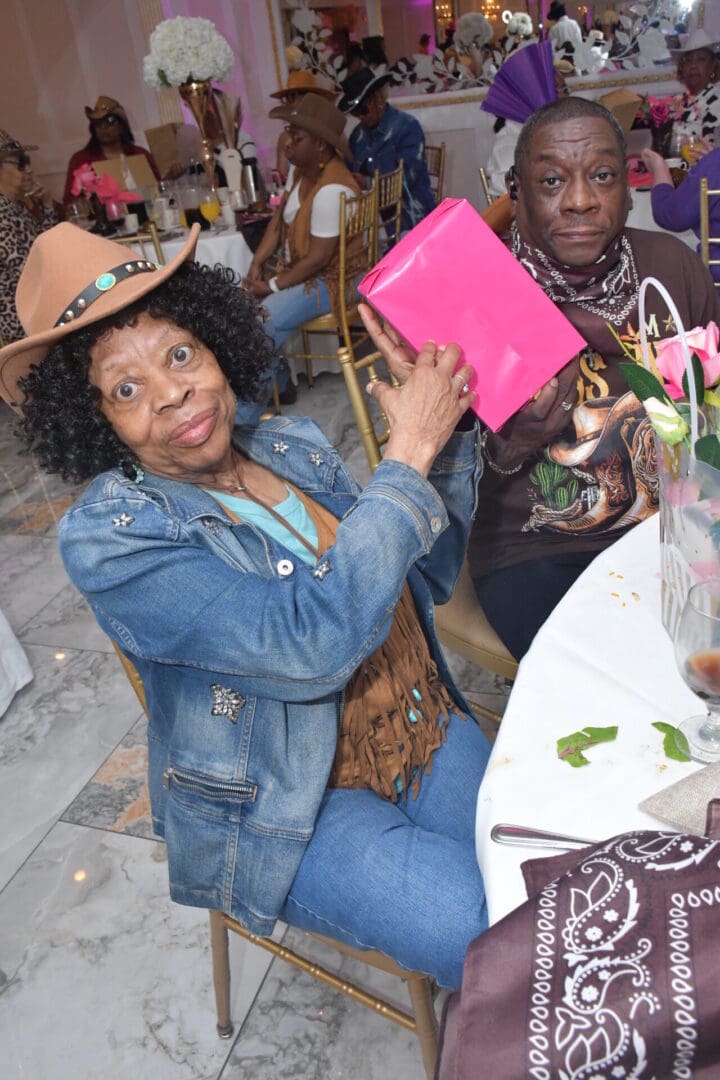 Older couple at celebration with gifts.