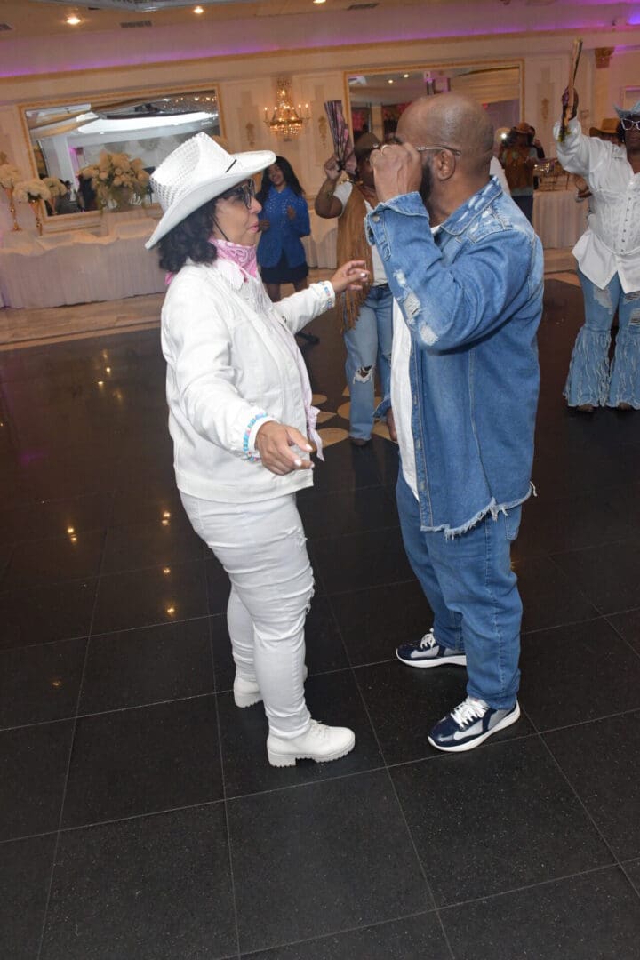 Dancing couple in casual attire indoors.
