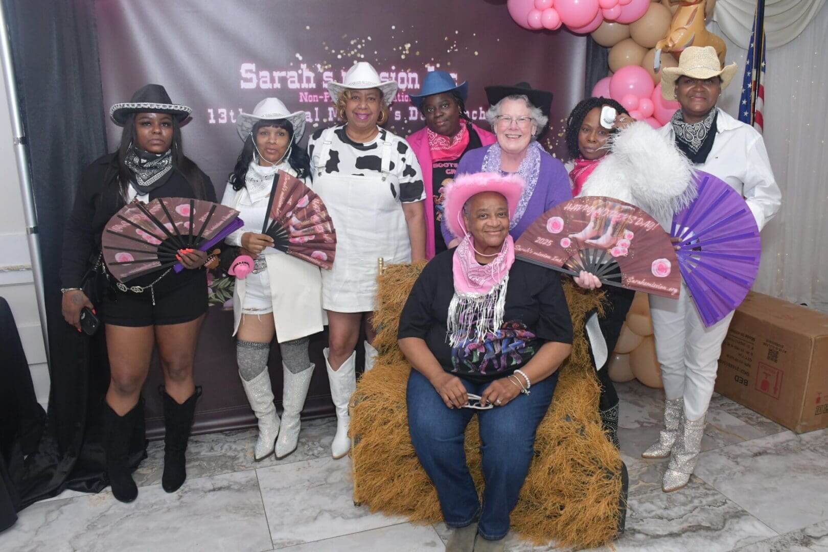 Group in western attire with fans.