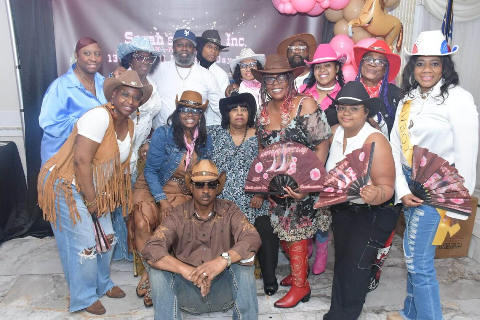 Group in cowboy-themed attire posing together.