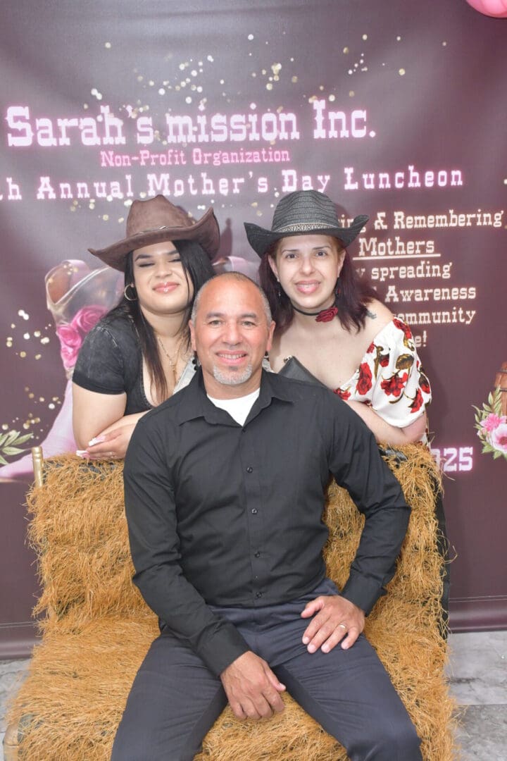 Three people posing at Mother's Day event.
