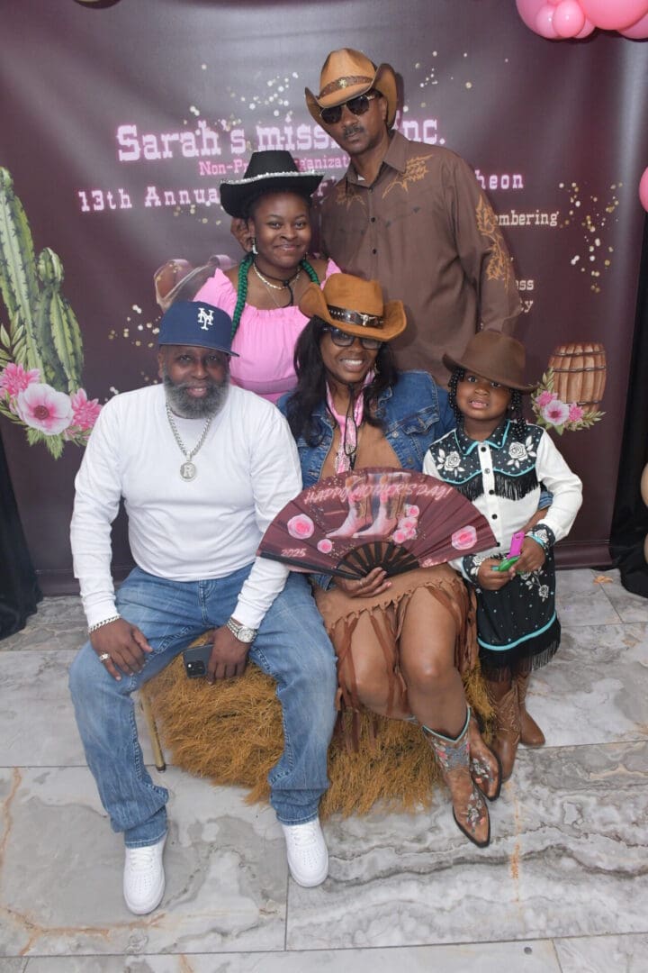 Family in cowboy-themed attire at celebration.