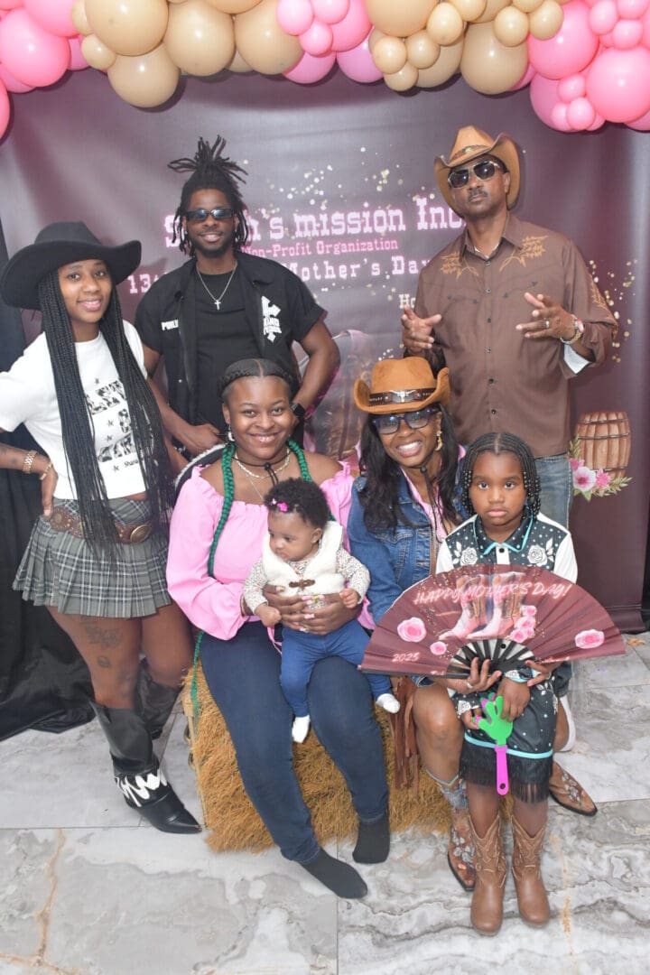 Group posing in cowboy-themed attire, smiling.