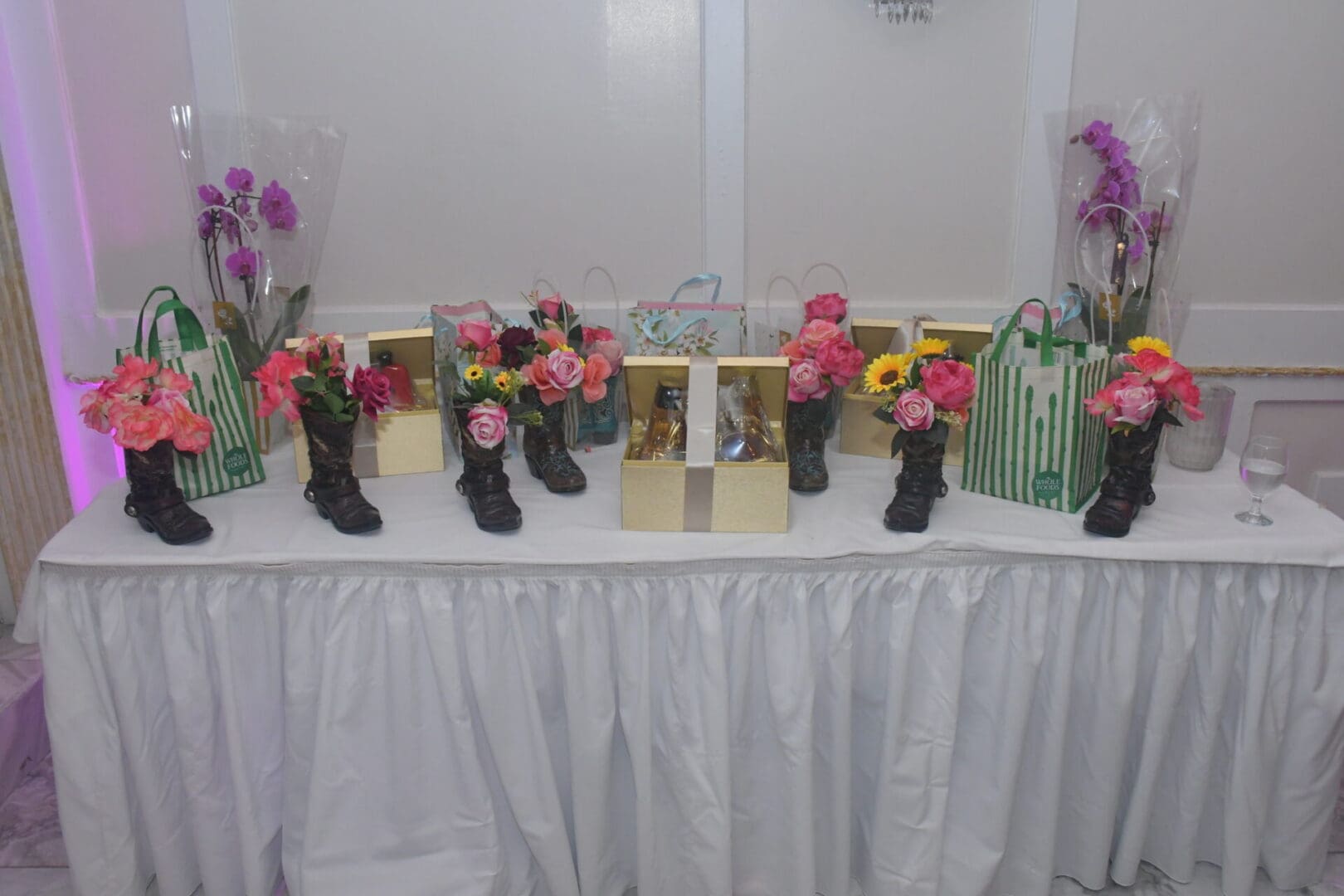 Table with flowers and gift bags displayed.