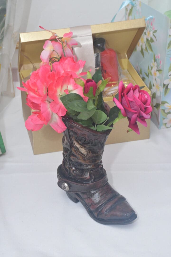 Boot-shaped vase with colorful flowers arrangement.