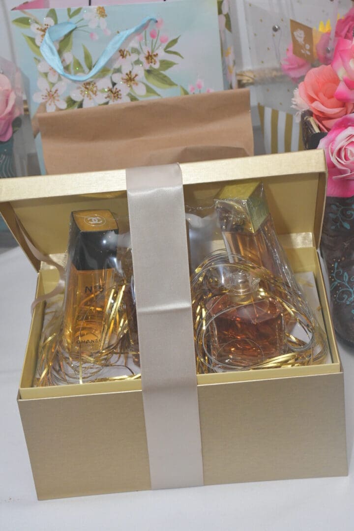 Gift box with perfumes and floral decorations.
