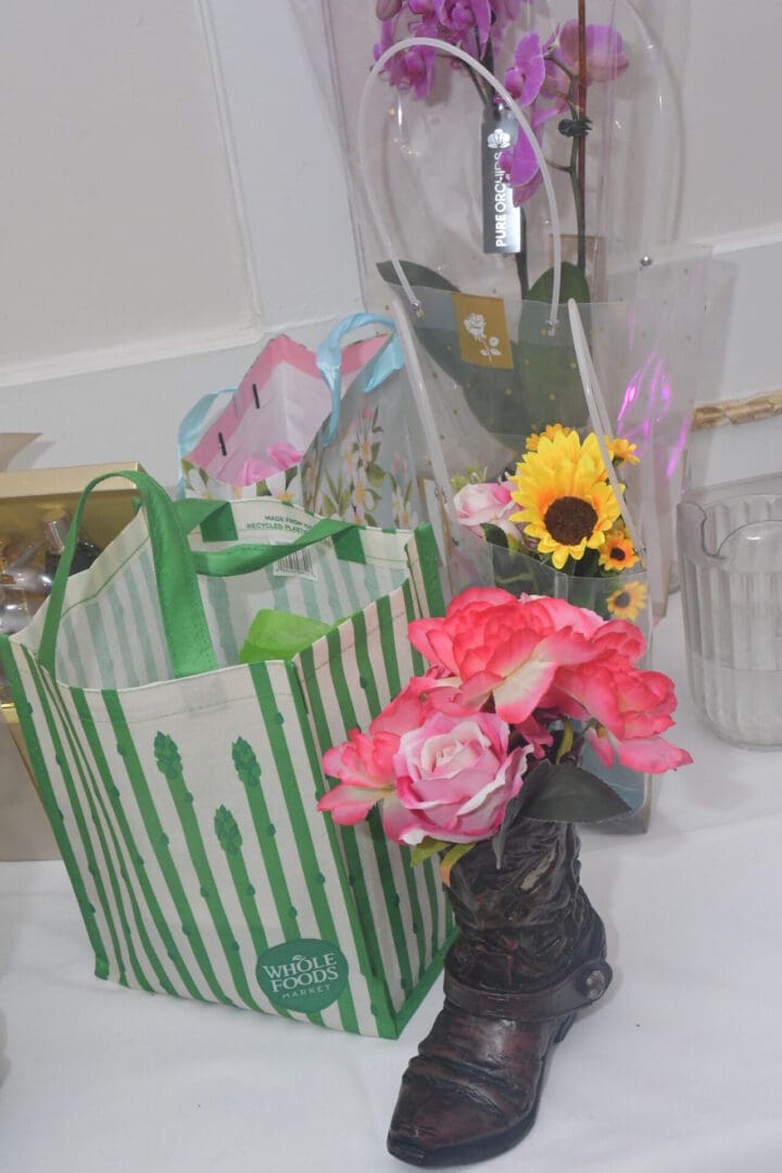 Flowers in a boot vase, striped bag.