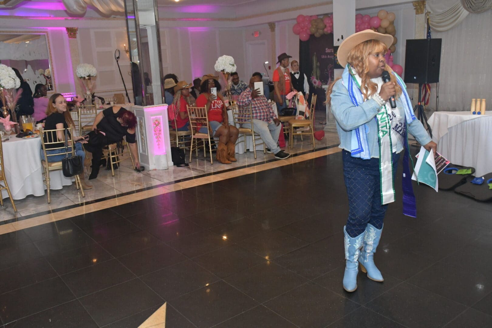 Person speaking at a lively indoor event.