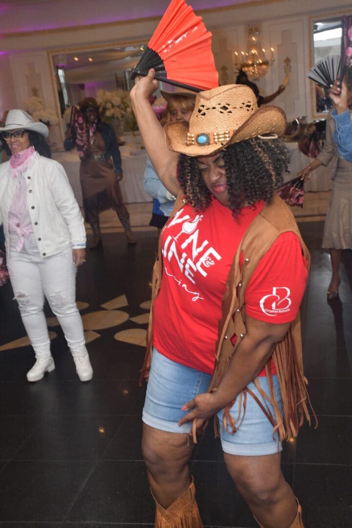 Person dancing in cowboy hat and boots.