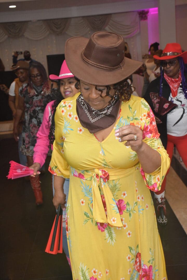 Woman in yellow dress at themed party.