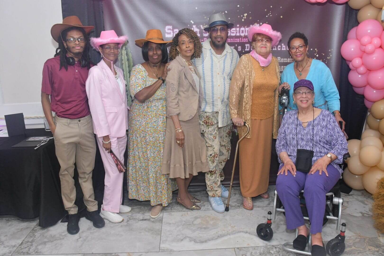 Group posing with colorful hats and outfits.