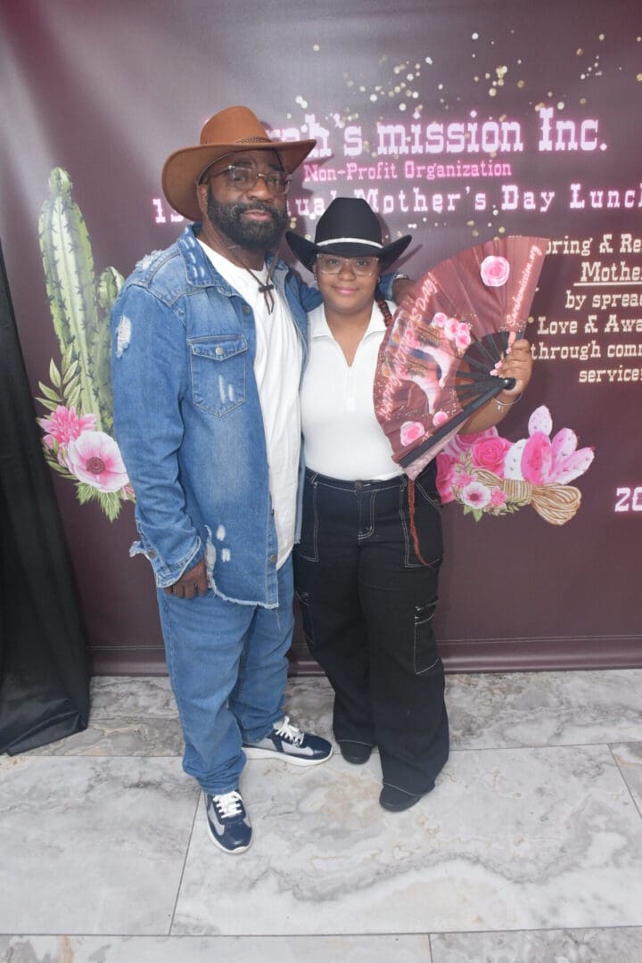 Man and woman in cowboy hats smiling.