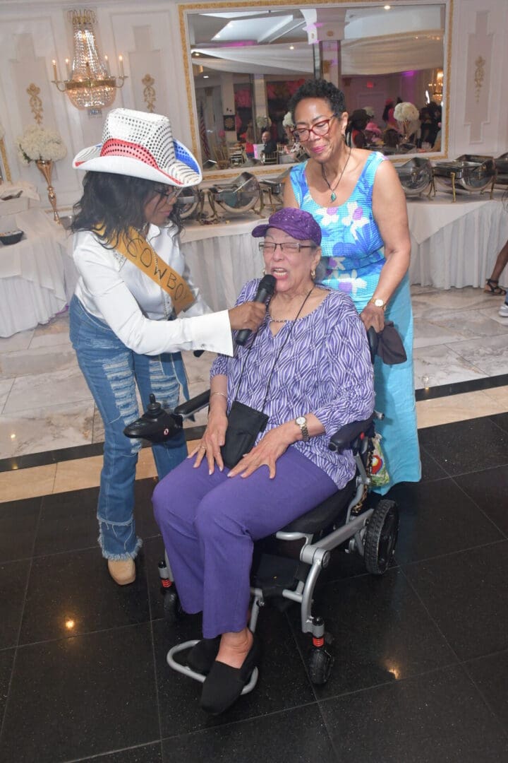 Three women at an indoor event.