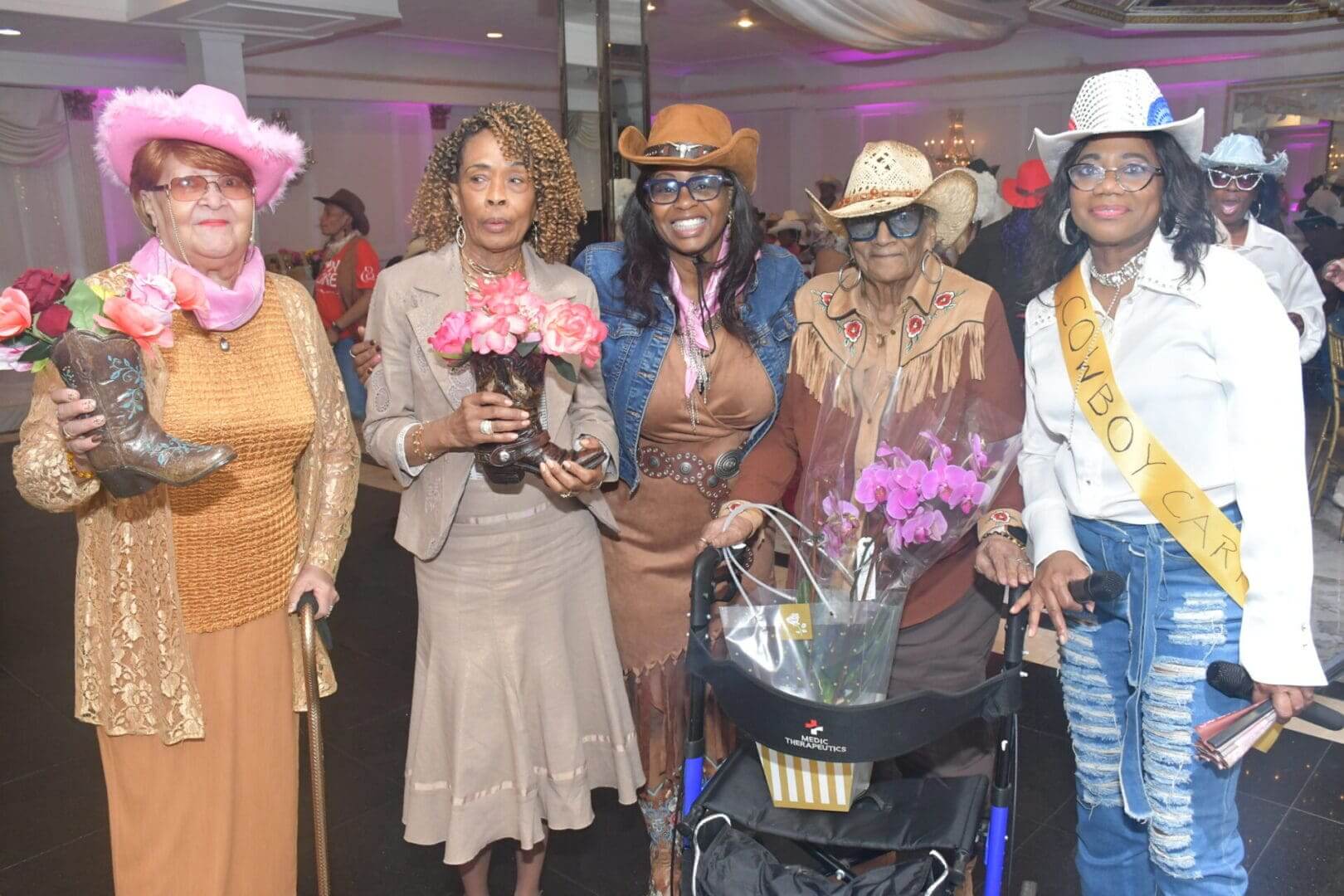 Group of women in cowboy-themed outfits.