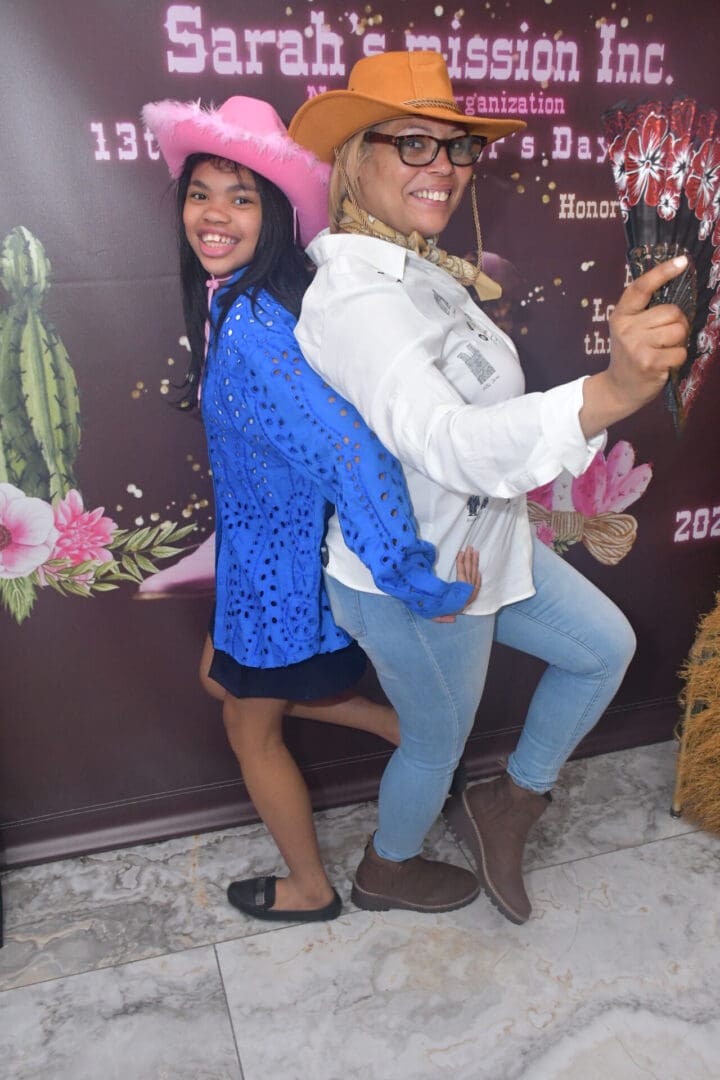 Two people posing in cowboy hats.