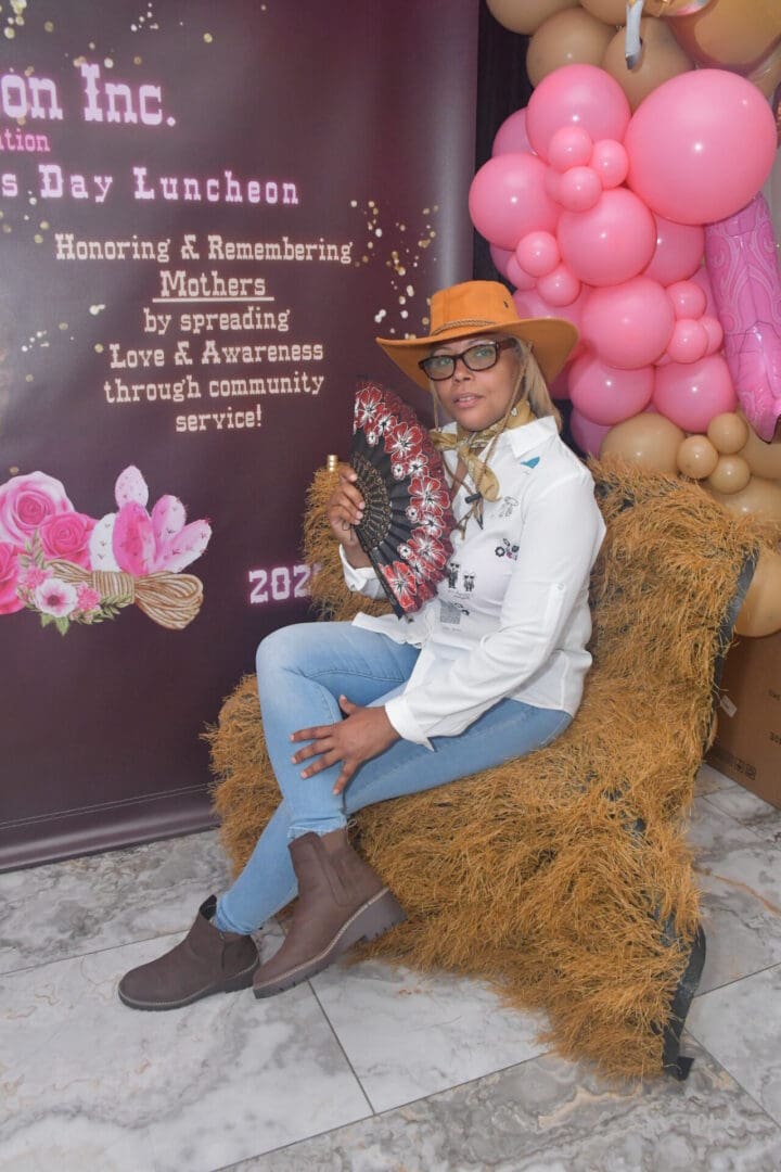 Cowgirl-themed event with woman and balloons.