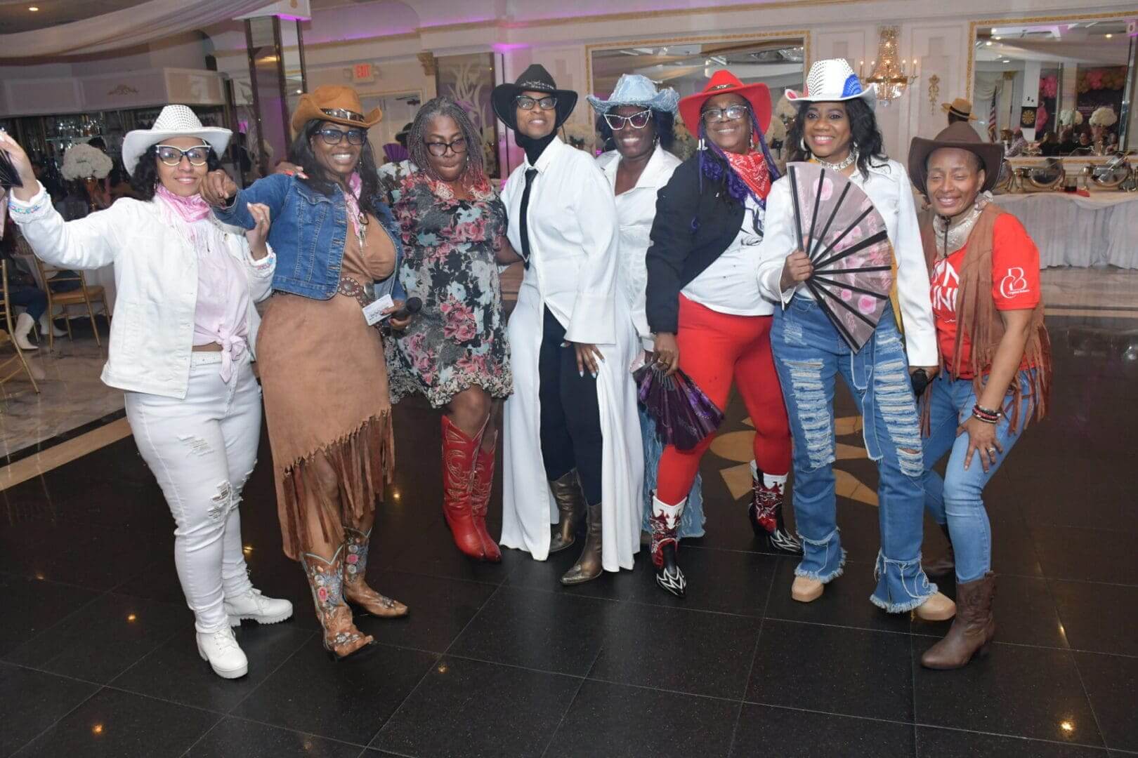 Group in cowboy-themed attire at event.