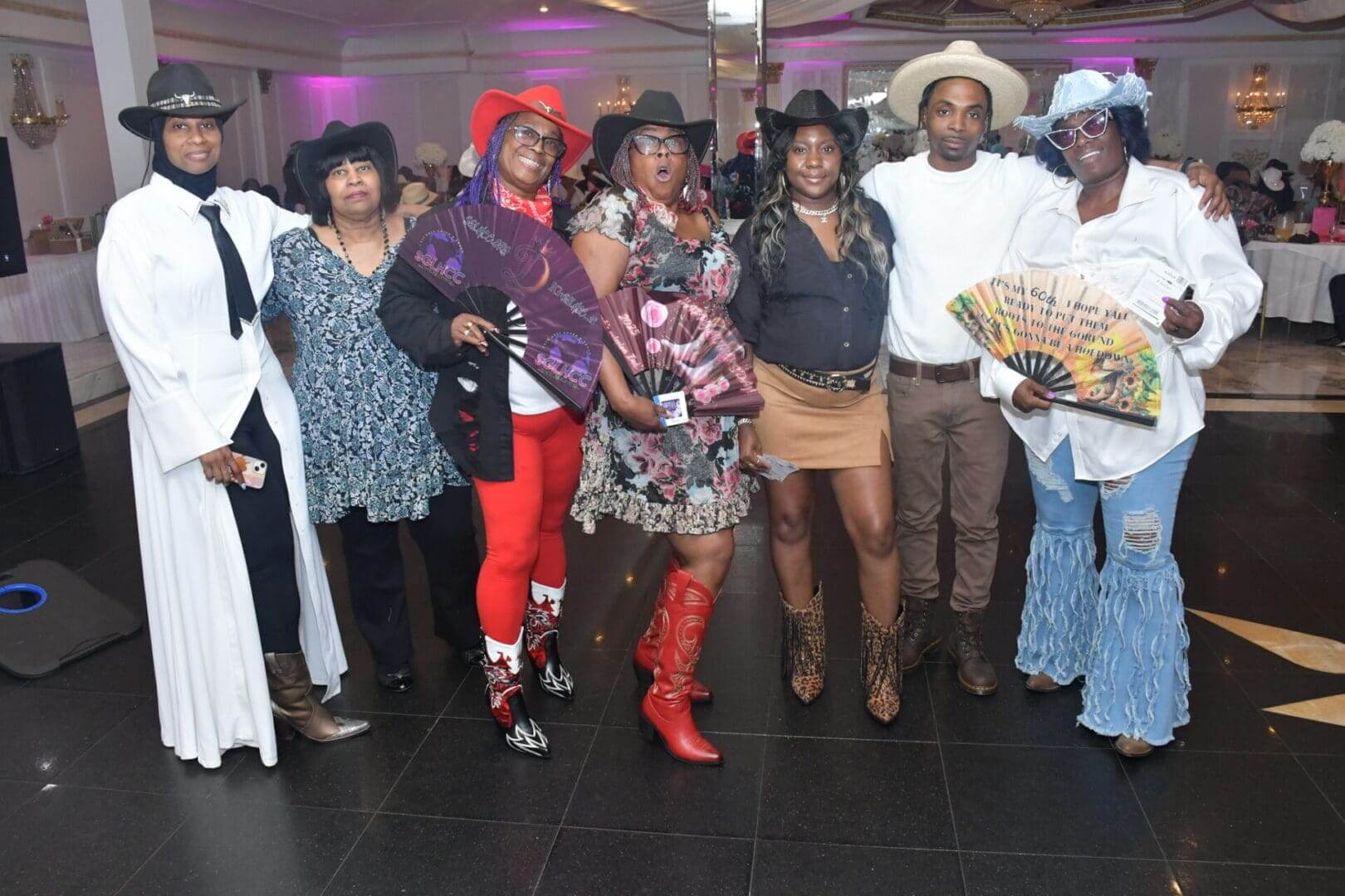 Group in western attire at indoor event.